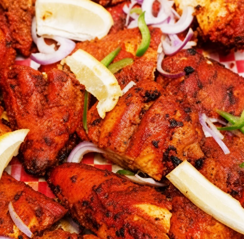 Tandoori chicken marinated overnight in yogurt and spices and grilled in the clay oven at Darbar Restaurant, downtown Saskatoon